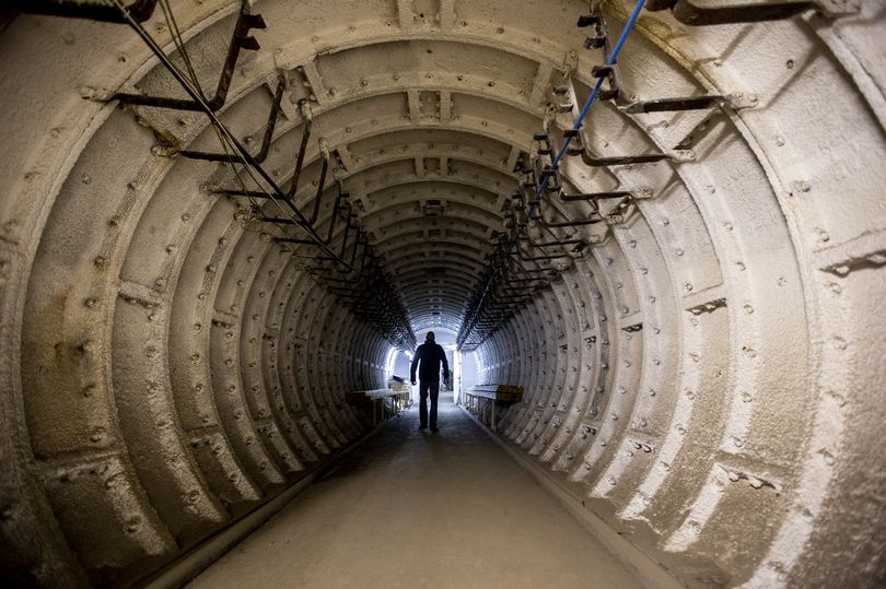 A of a man walking down a passageway.