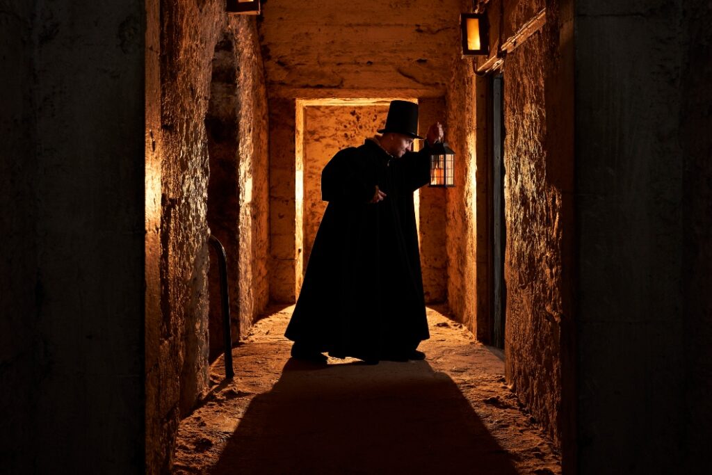 The witch pricker looks through a doorway