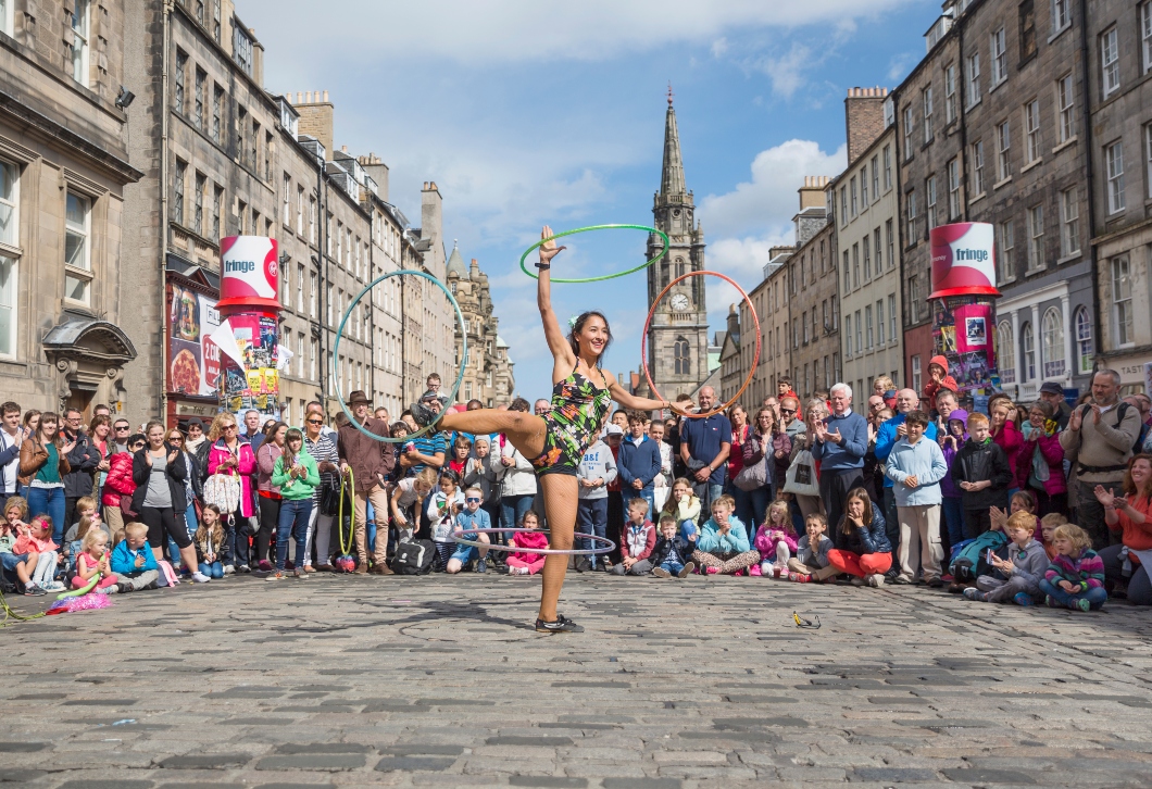 Performer at Edinburgh Fringe on the Royal Mile spinning hoops